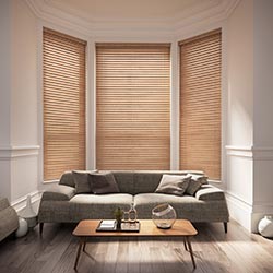 A brown wooden blind in a bay window