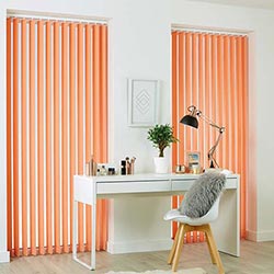 Coral orange vertical blinds, fitted in narrow windows in an office.