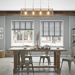 A dining room with a double grey taped wooden blind look