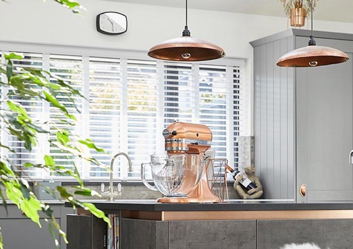 An image showing a wooden blind in a kitchen with copper interior