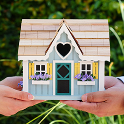 People holding a beautiful homemade miniture wooden house