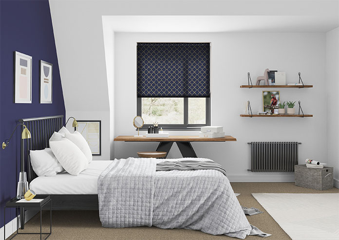 A blue and gold patterned roller blind in a minimalistic bedroom
