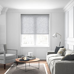A spotty black and white roller blind in a neutral living room
