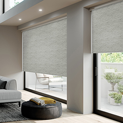 A grey textured roller blind in a living room