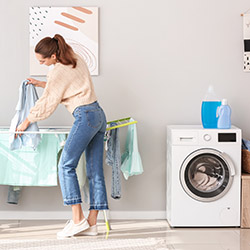 A woman doing her washing and hanging her clothes