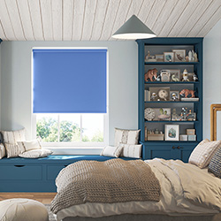 A bedroom is shown with a azure blue roller blind adoring the window.