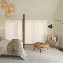 A neutral bedroom with a wide window with cream extra wide vertical blinds in it.
